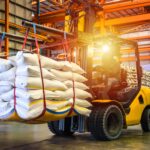 battery powered forklift carrying heavy products in warehouse