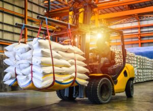 battery powered forklift carrying heavy products in warehouse