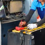 employees performing maintenance on forklift batteries